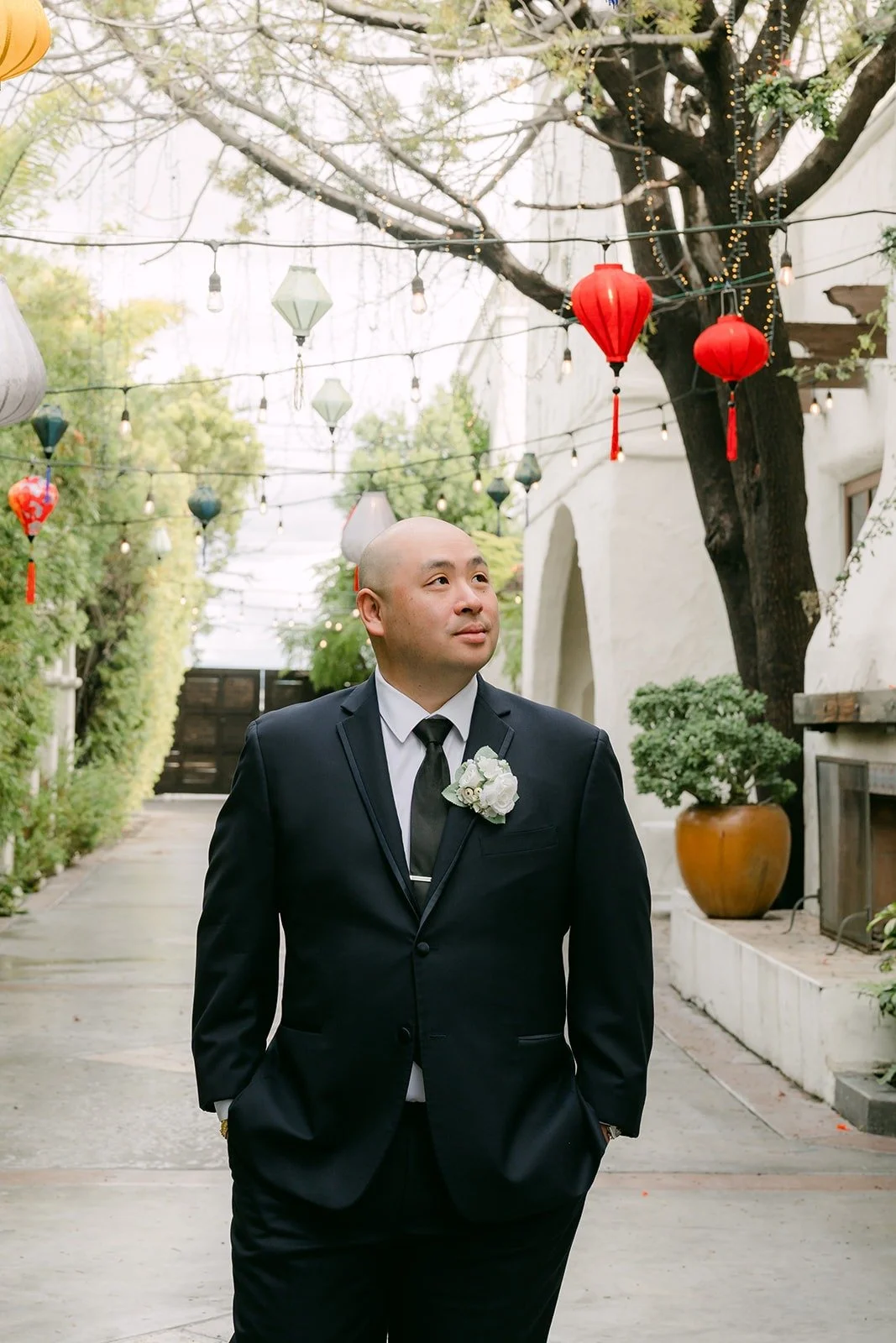 Yao in his navy suit with a white boutonniere