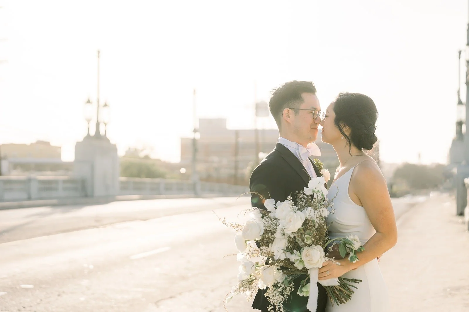 Cindy and Alex on the rooftop with the Los Angeles skyline beyond them
