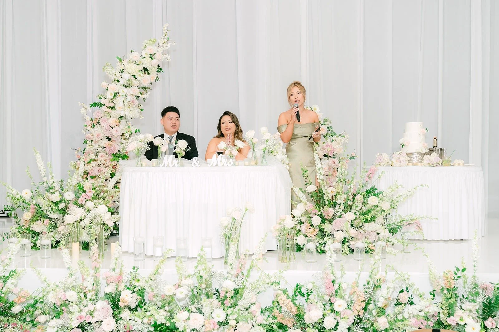 Candice and Vincent at the sweetheart table during speeches