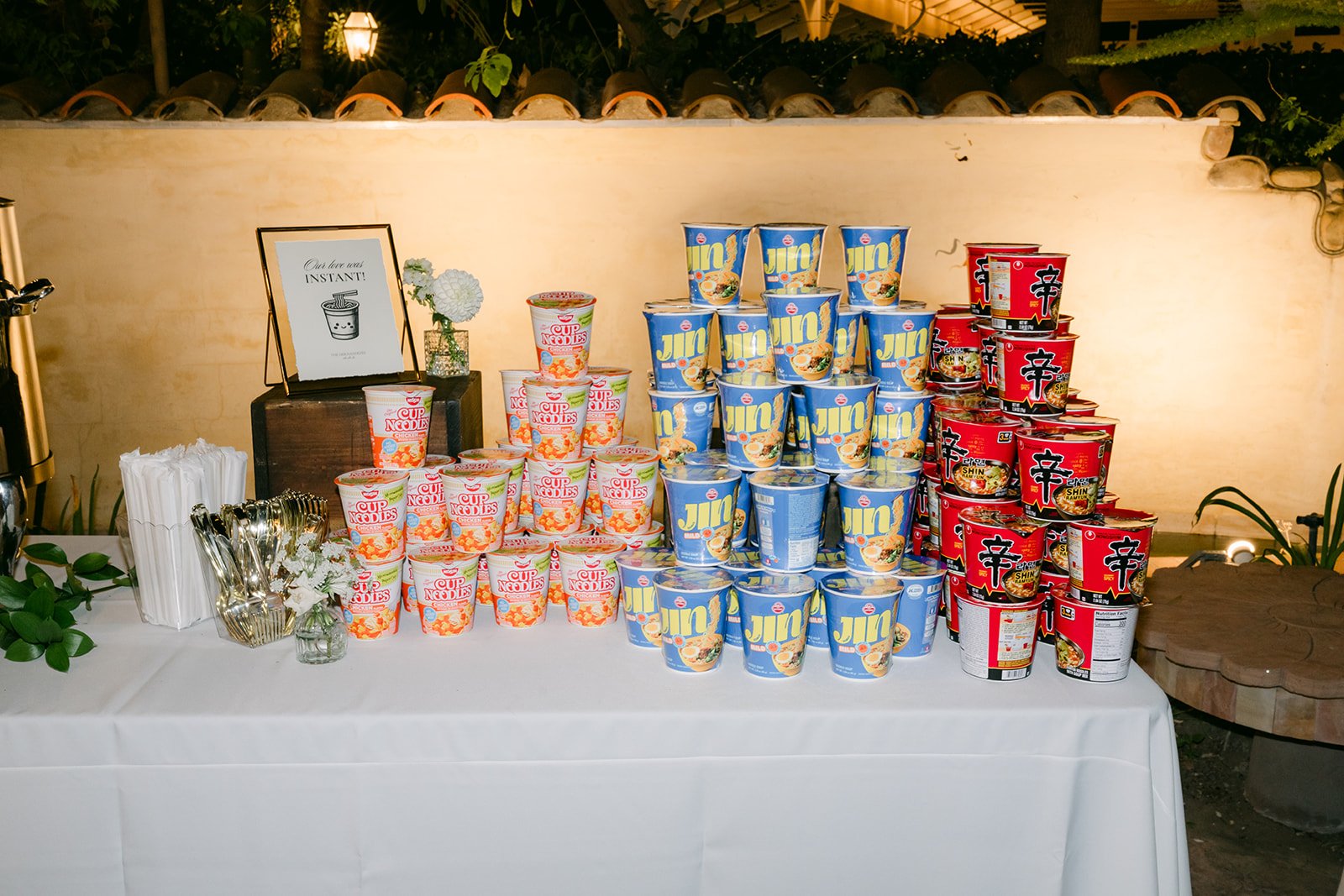 A treat table stacked with snack cans for guests.
