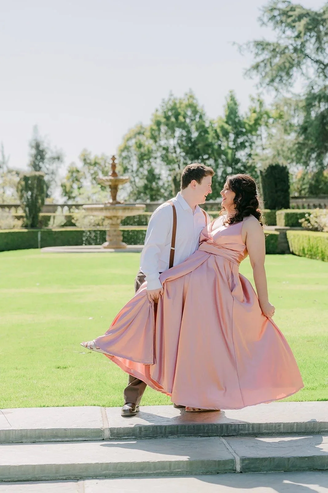 Matthew spins Saira on the lawn as her blush gown flares.