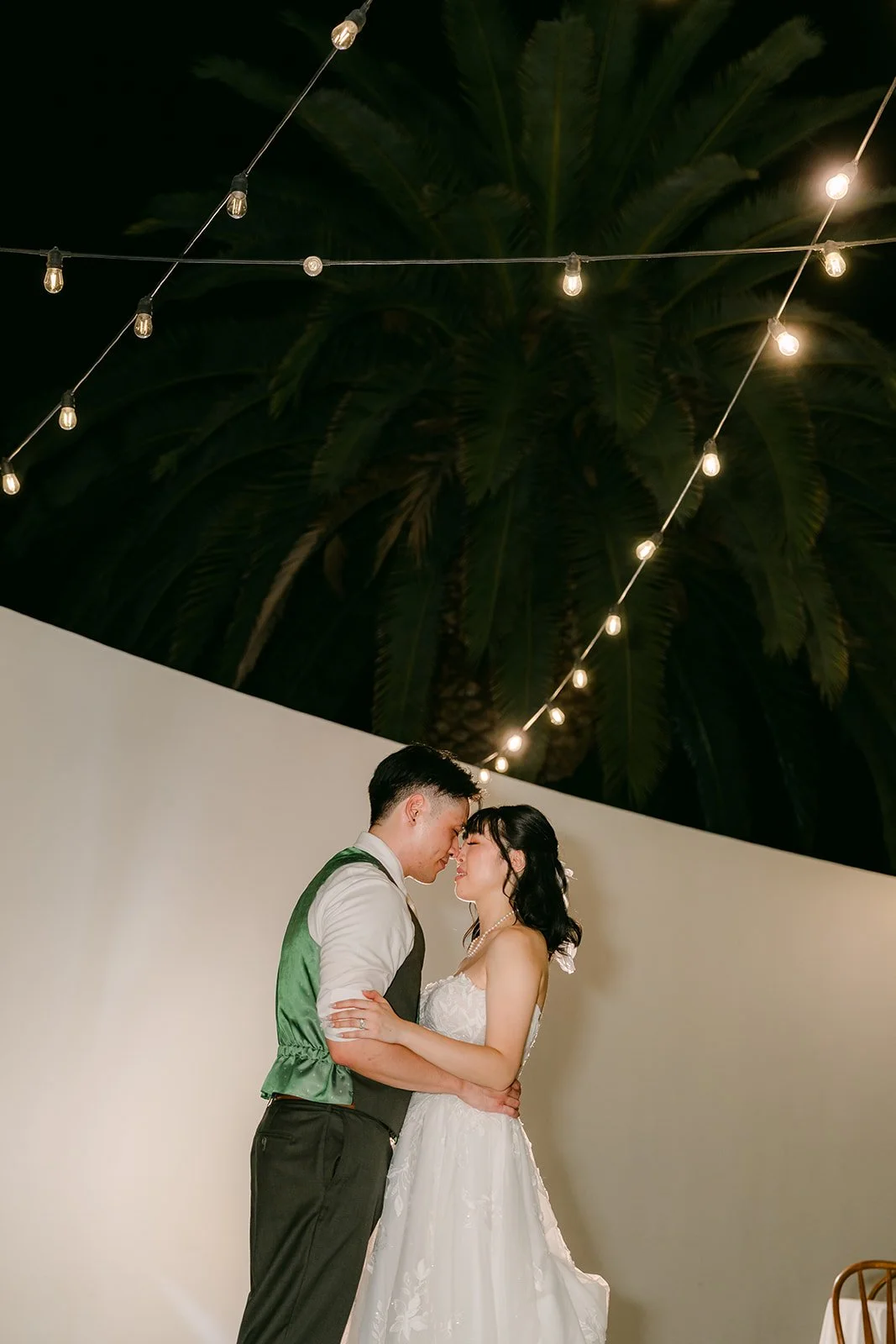 Night portrait under the string lights on the Colony House patio in Anaheim