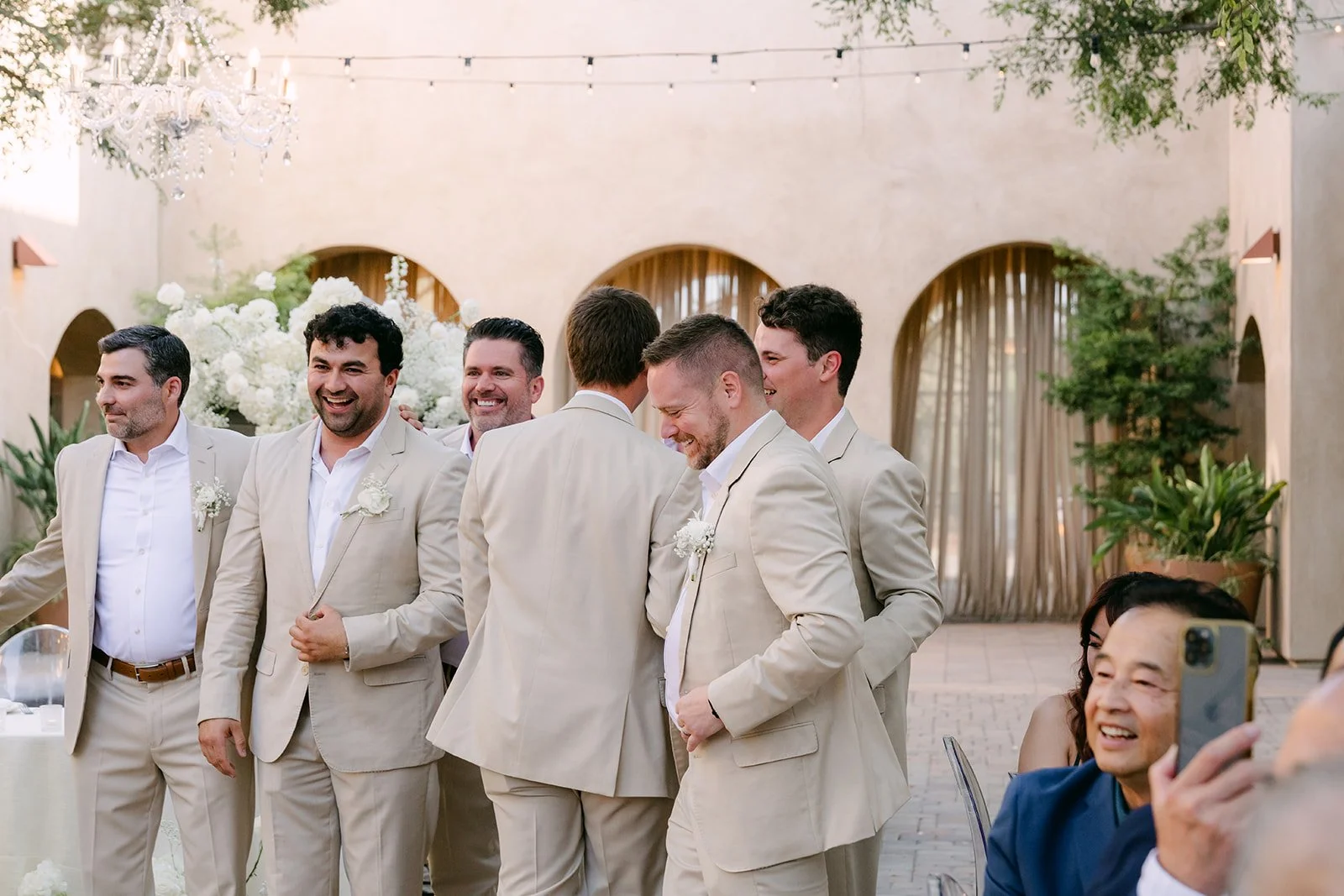 Groomsmen posing in a line during the grand entrance