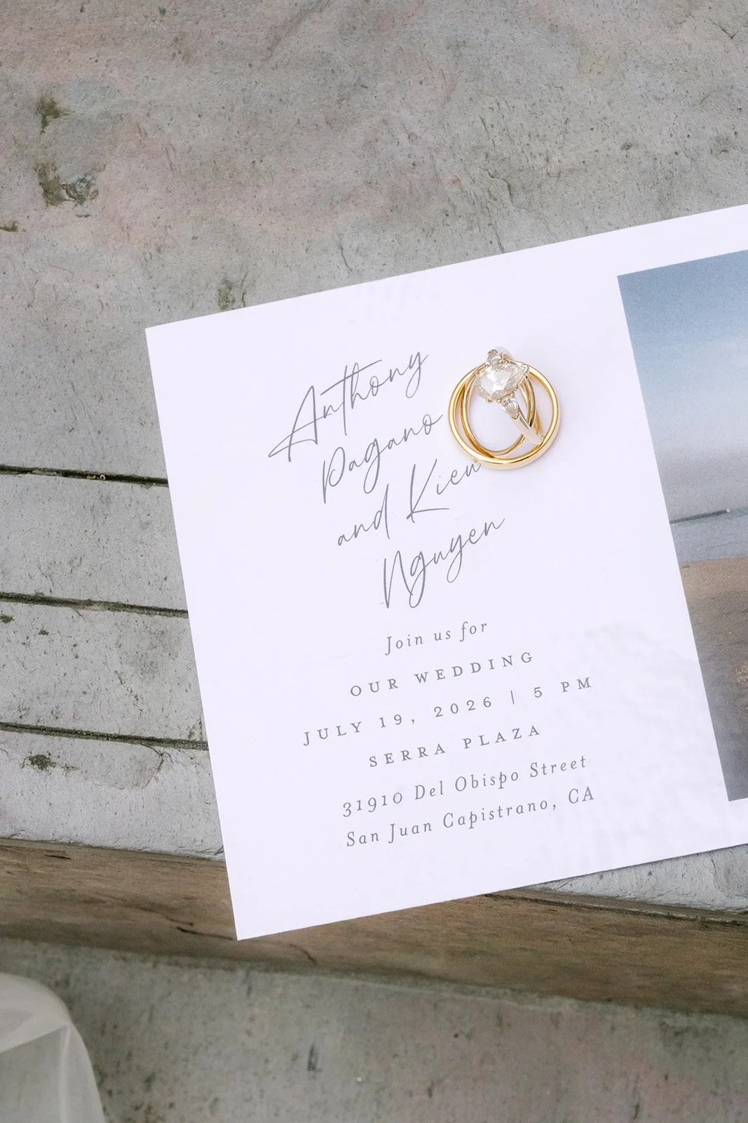 Kieu and Anthony wedding invitation with engagement ring resting on top