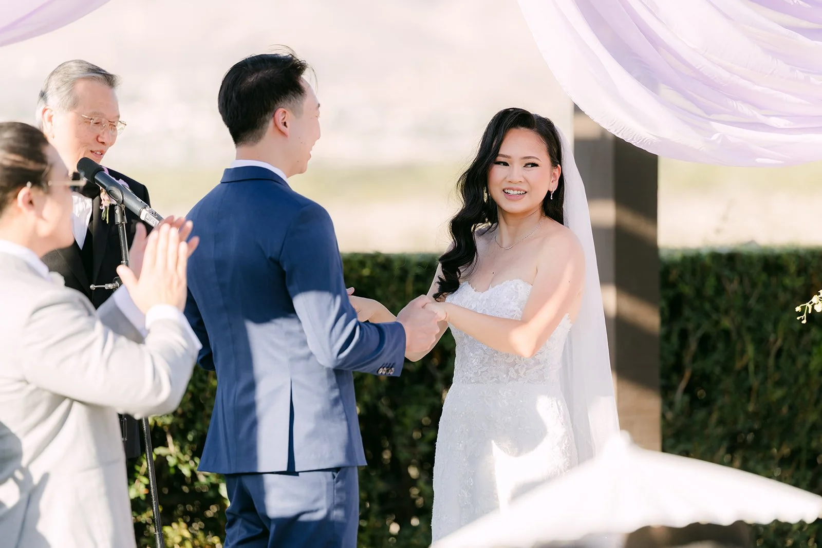 Elijah's mom singing for the couple during the ceremony.