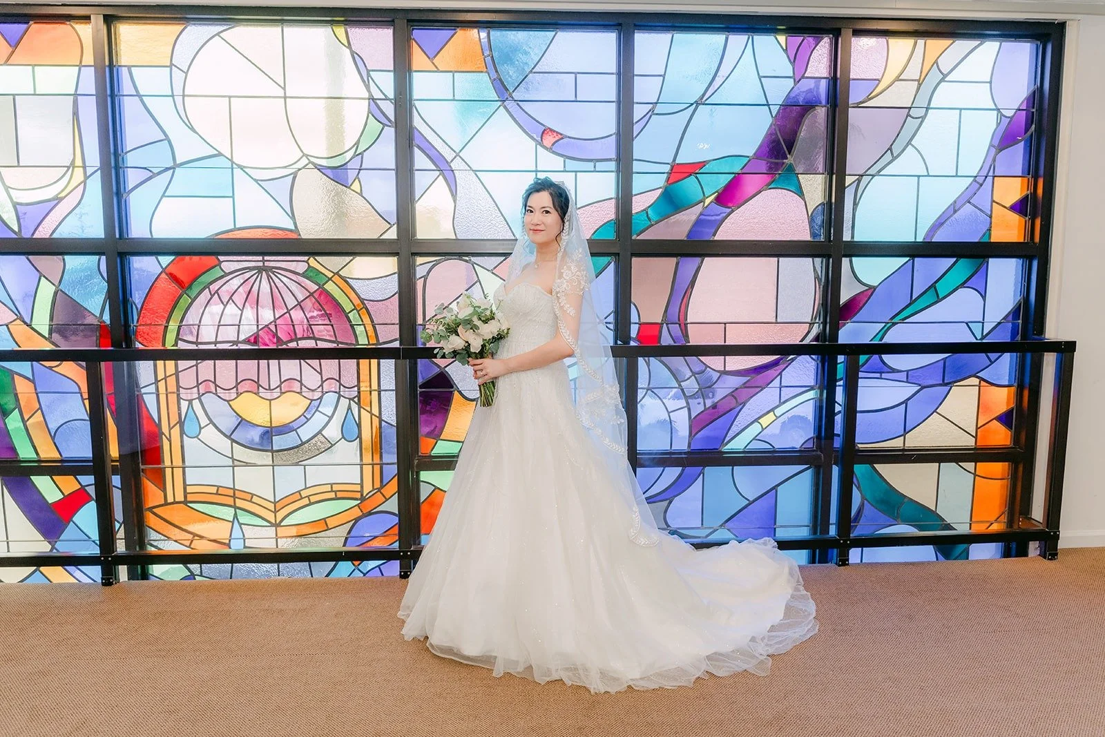 Eunice in her gown in front of the Rainbow Glass Wall