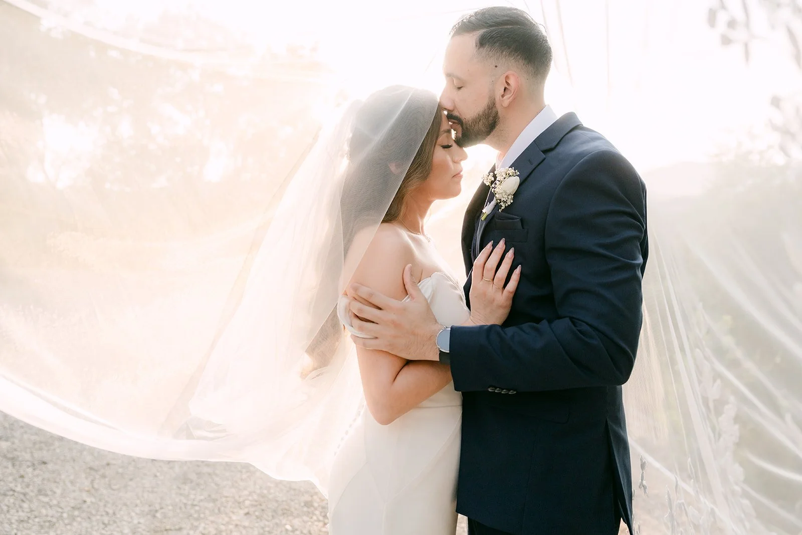 Danny kissing Mariana's forehead with the veil glowing around them