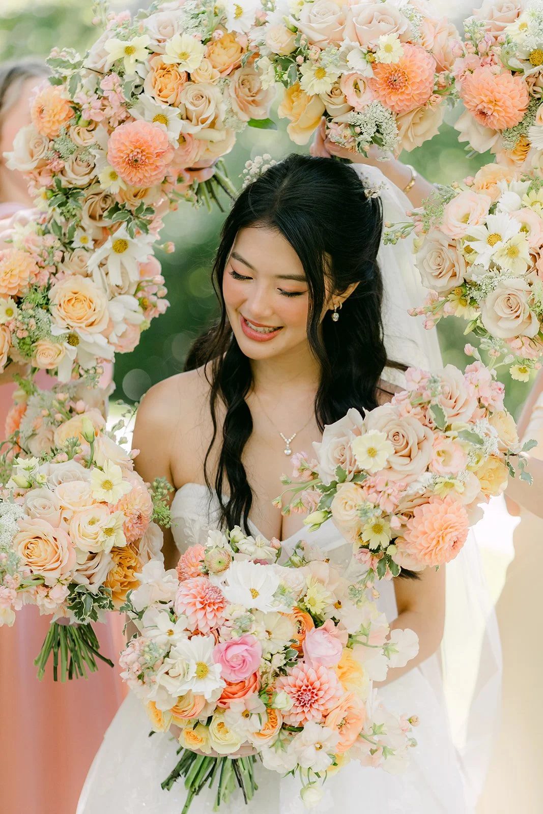 Clarissa surrounded by her bridesmaids' bouquets