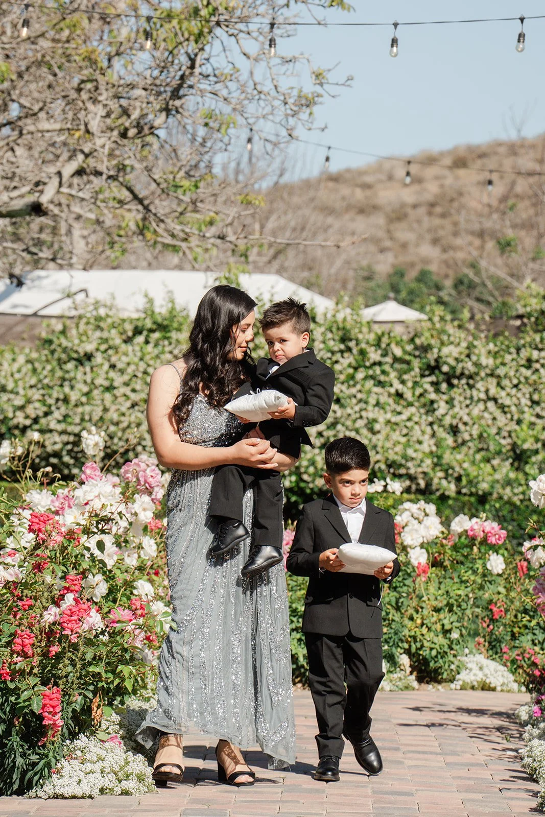 Ring bearers walking down the aisle with a guest