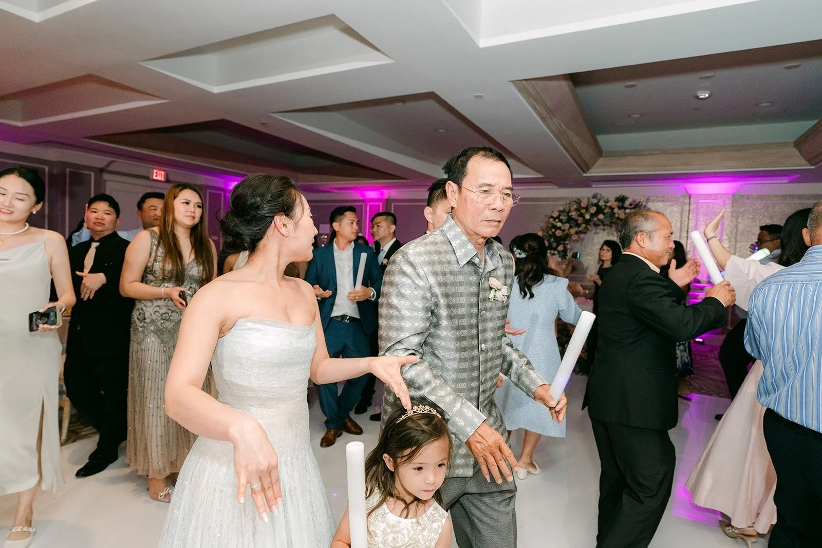Kylie dancing with guests under purple lights