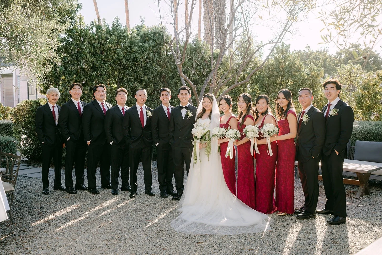 Jadee and Richard with the full wedding party in the garden at The Harper