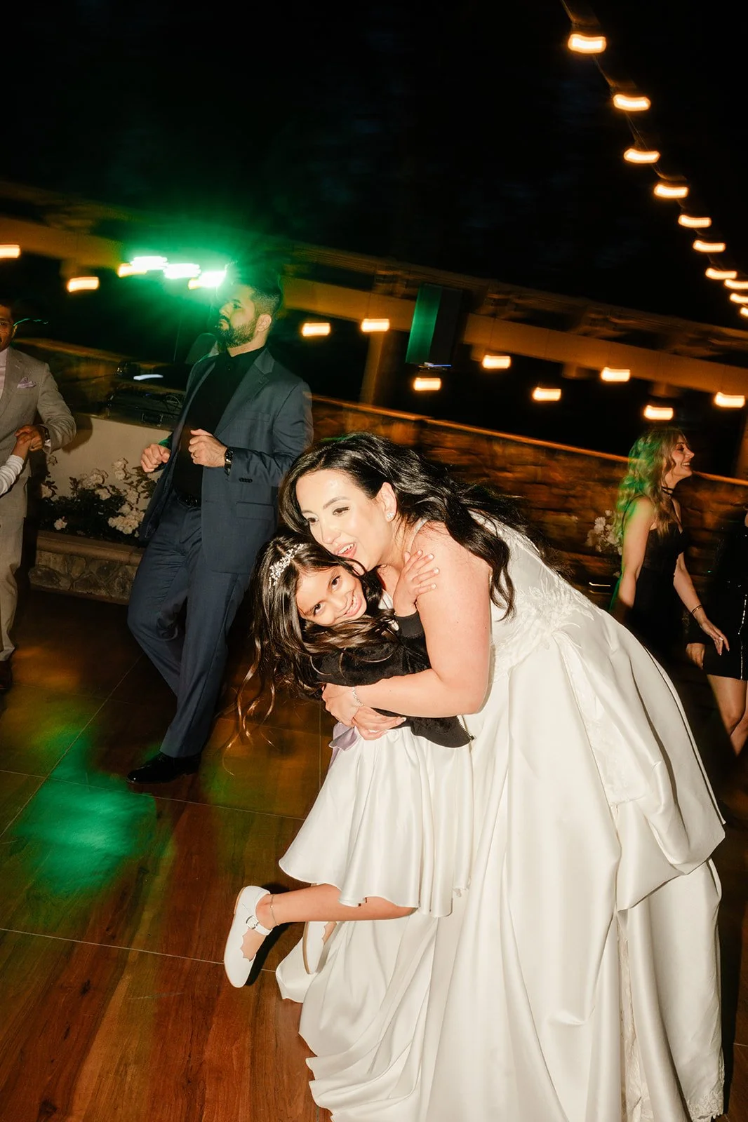 Bride lifting a friend on the dance floor