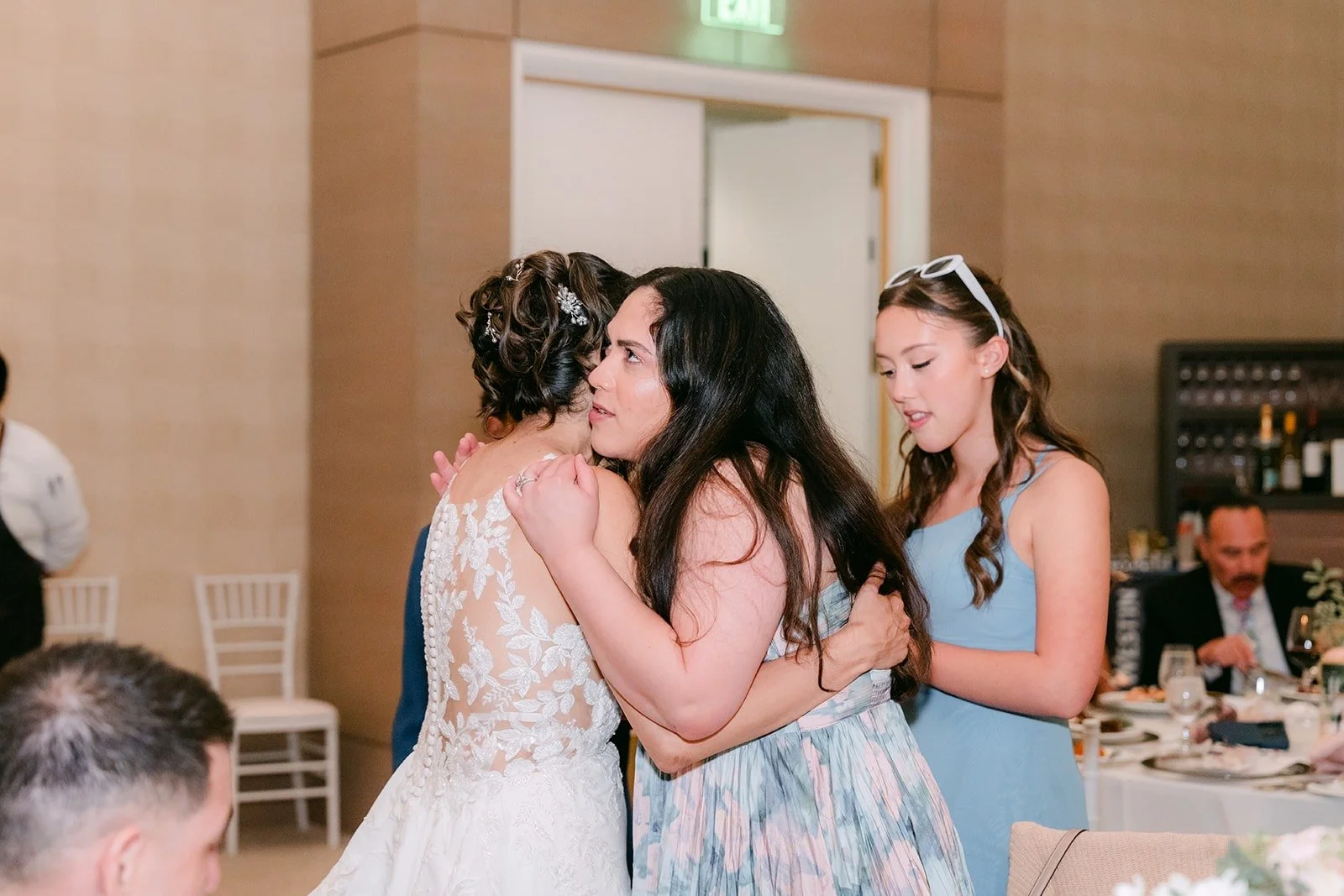 Francesca hugs a guest during table visits