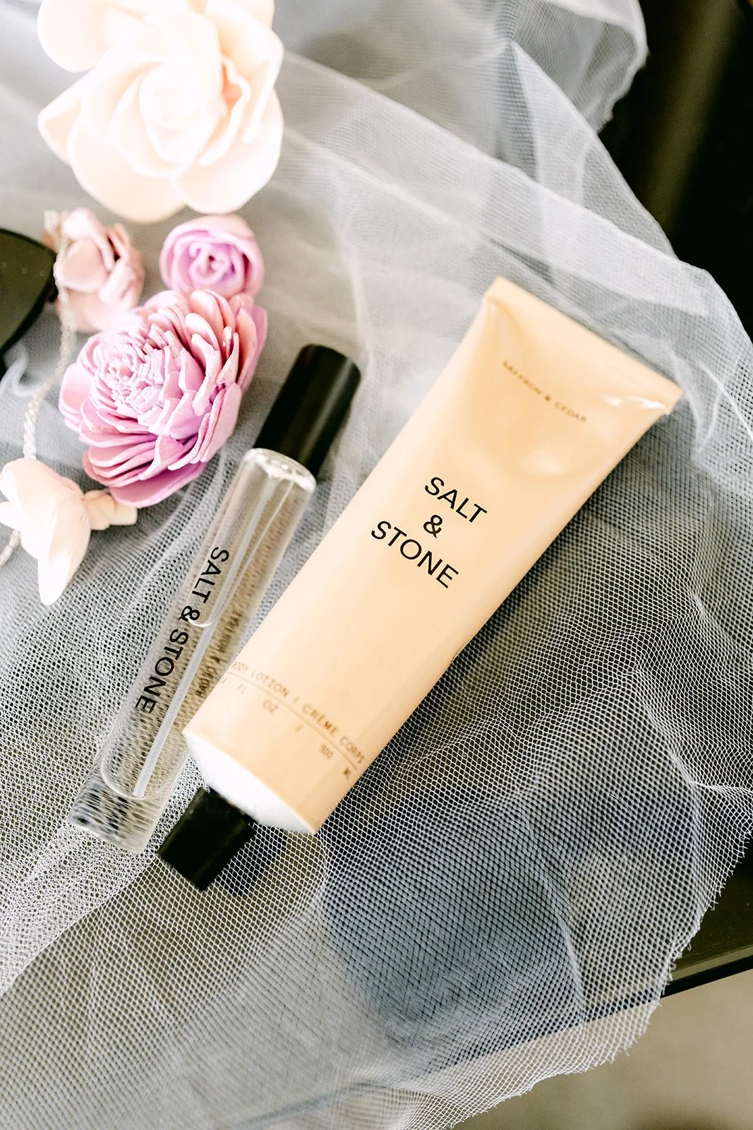 Perfume and lotion styled with lavender flowers.