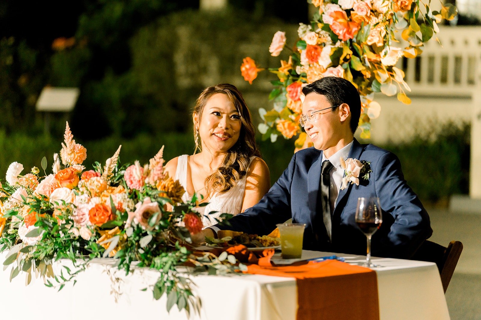 Ariel and Alex laughing during the toasts, photographed by One and Only Production