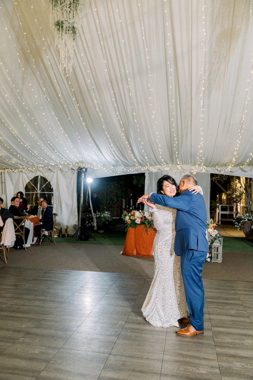 Hannah dancing with a family member under the tent