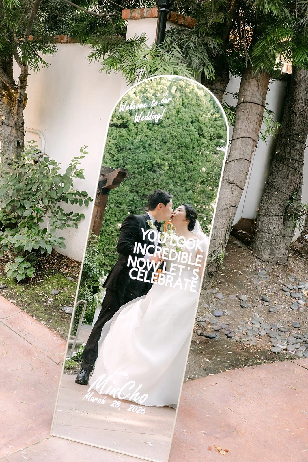 Chorok and Min Soo kissing, reflected in a tall arched mirror at Franciscan Gardens