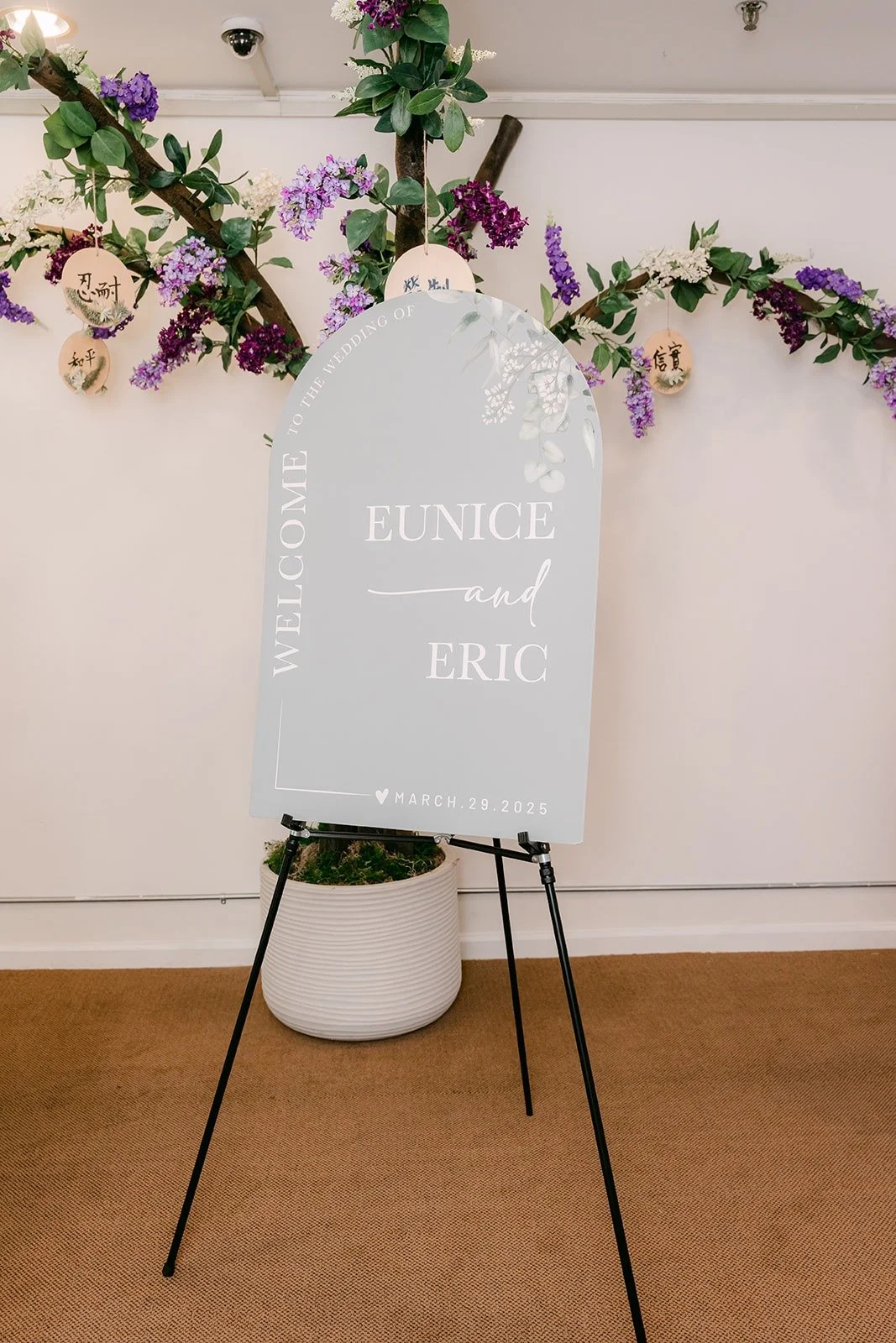 An arched welcome sign for Eunice and Eric framed by greenery at Mandarin Baptist Church of Los Angeles