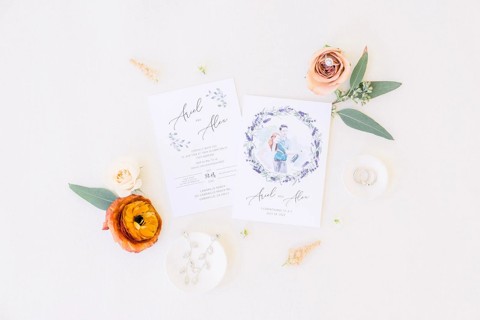 Ariel and Alex's invitation with orange and peach blooms, photographed by One and Only Production