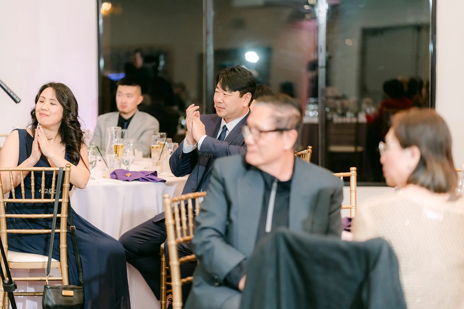 Guests laughing during the speeches.
