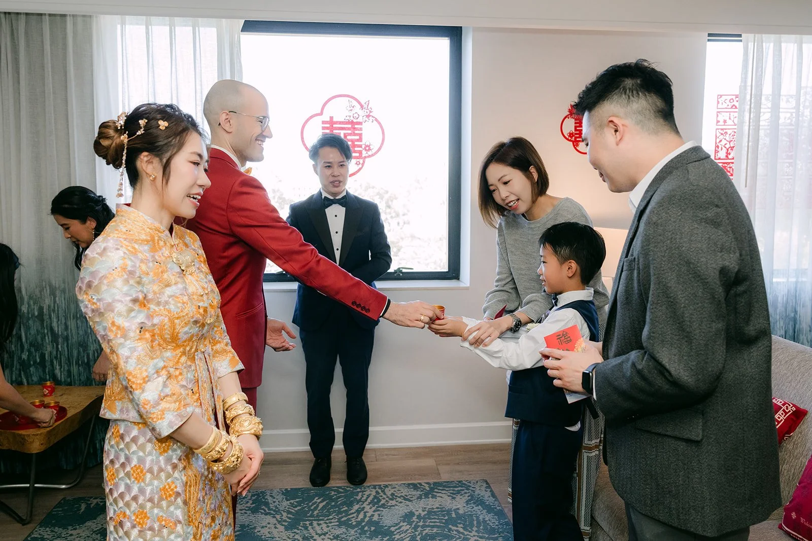 Christie and Christian receive a red envelope from a relative during the tea ceremony.