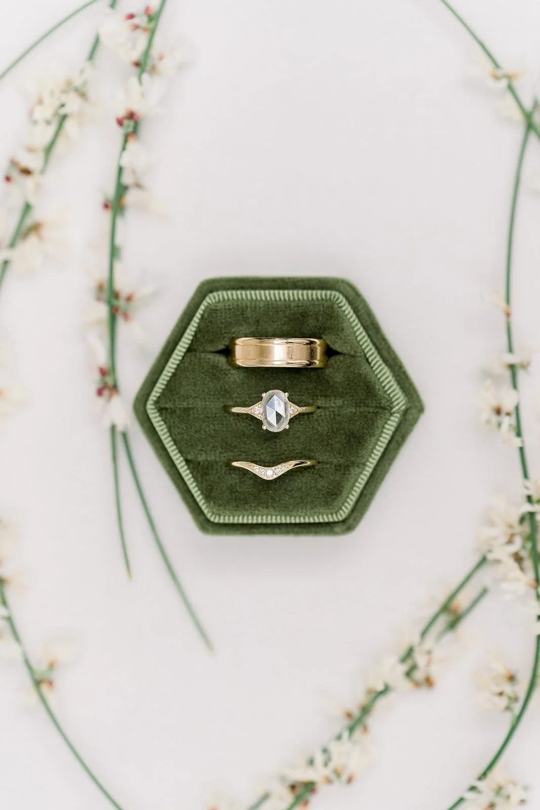 The green ring box styled with white blossom branches