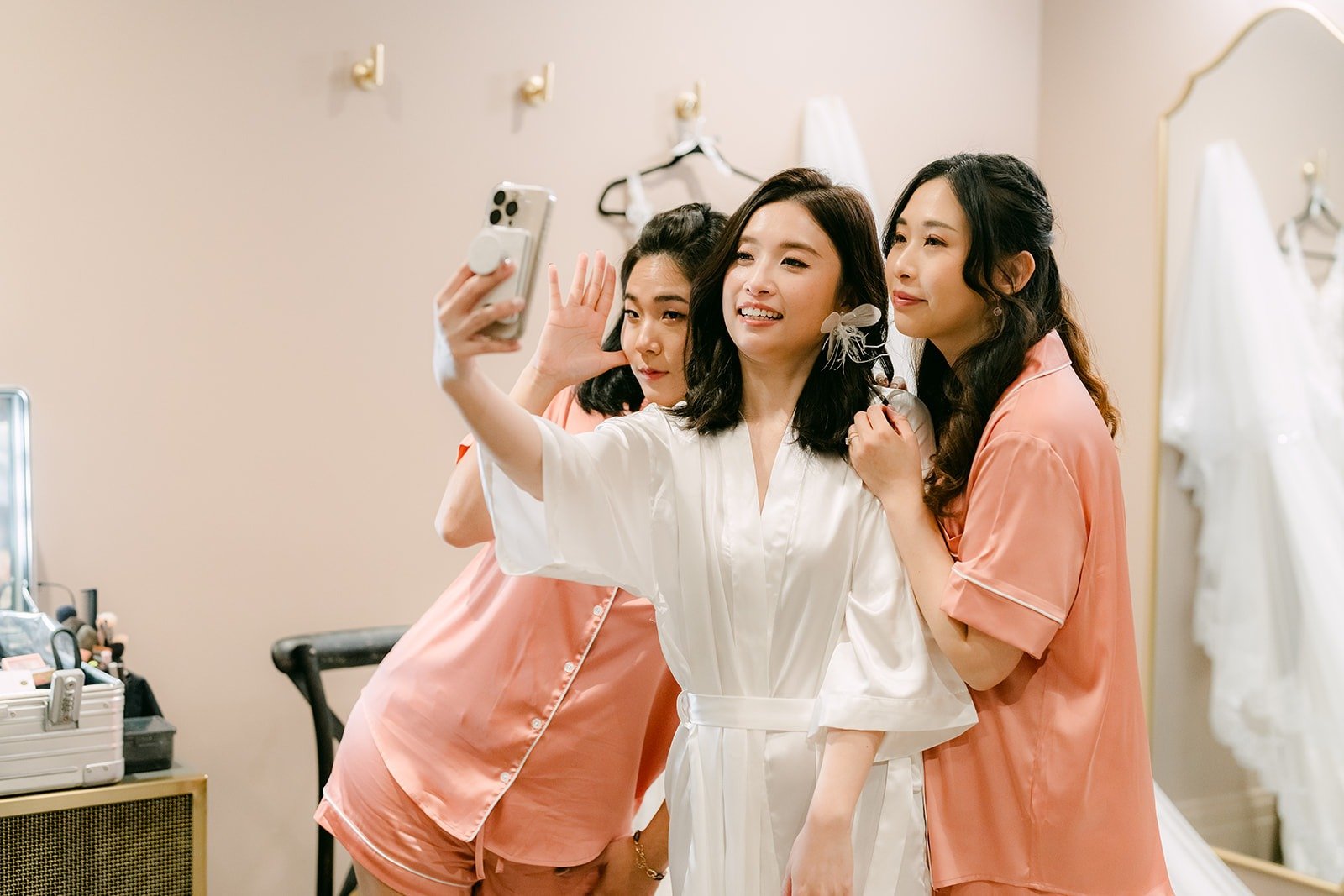 Elisa and her bridesmaids take a selfie in their robes