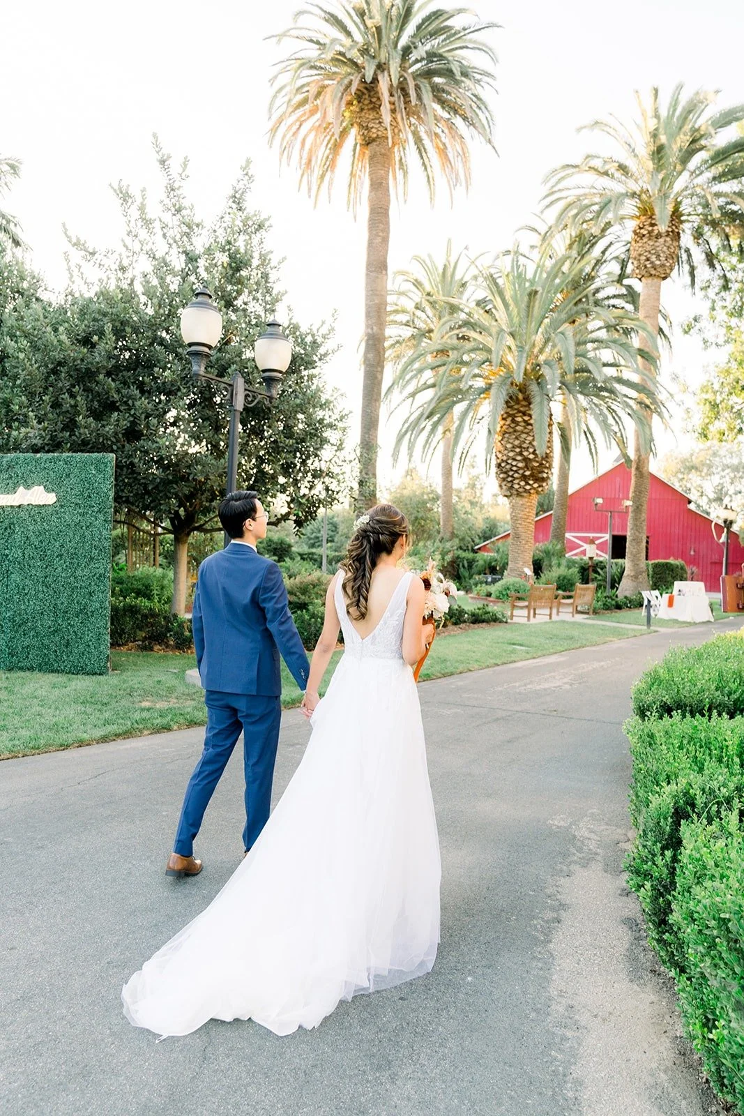 Ariel and Alex walking hand in hand on the garden path