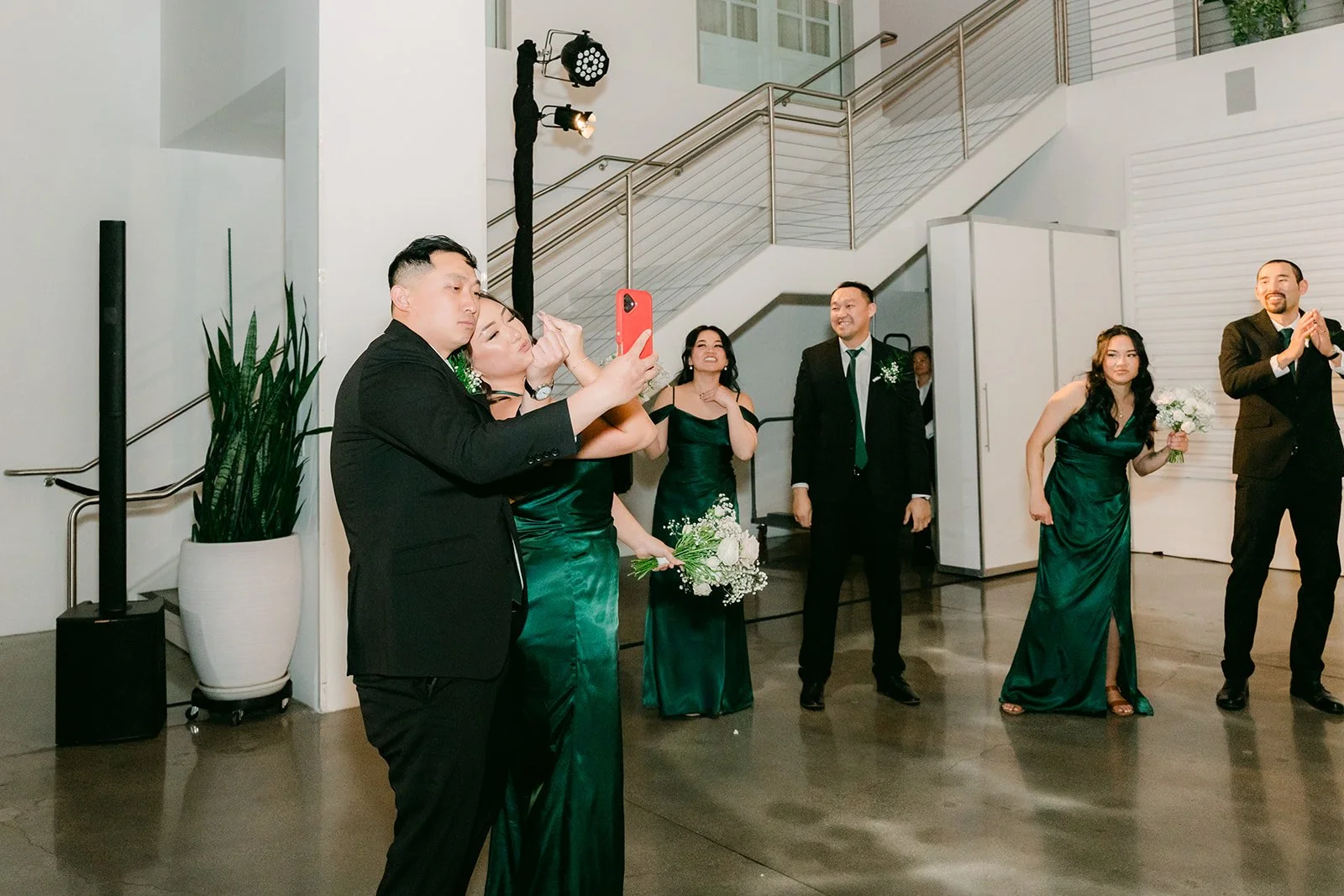 Wedding party dancing in by the staircase