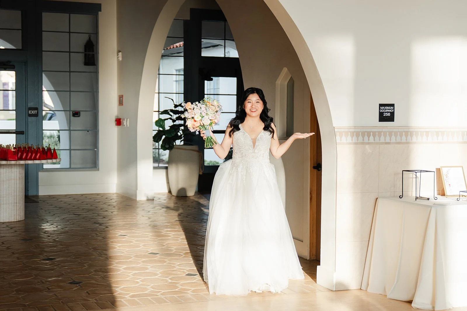 Constance waving as the newlyweds make their entrance