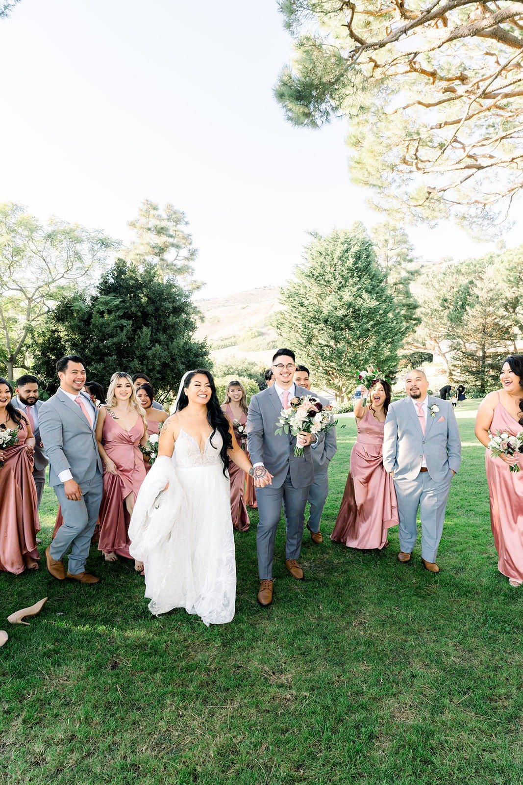 Betsy and Mikey laugh in the middle of their wedding party
