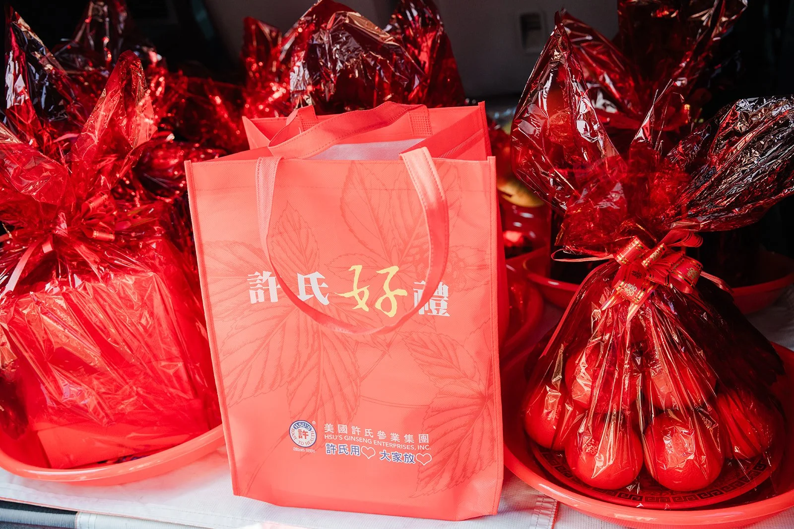 Red wrapped gift baskets and a red gift bag.