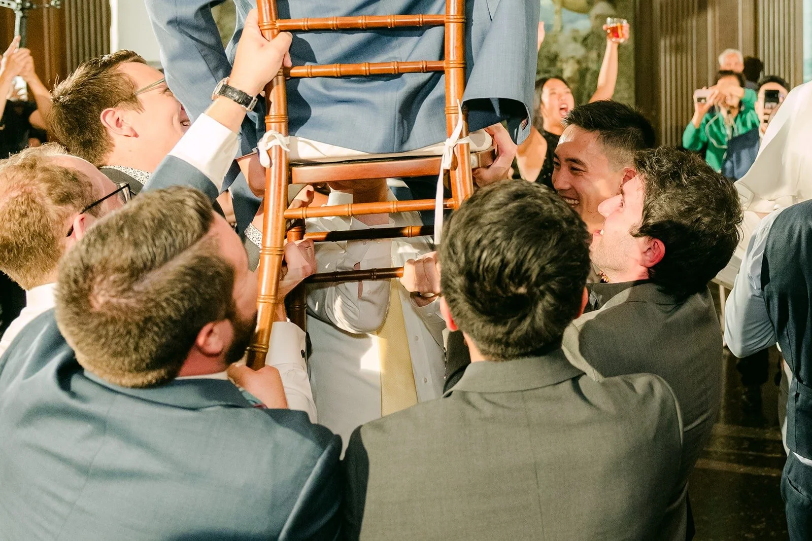 Guests lifting a chair during the Hora