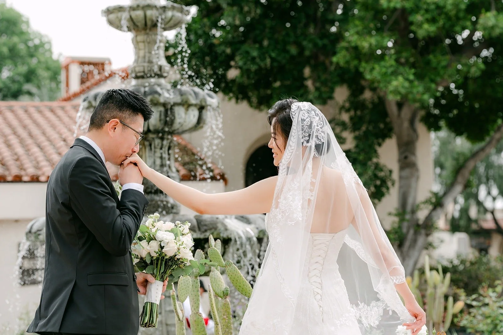 Eric kisses Eunice's hand by the fountain