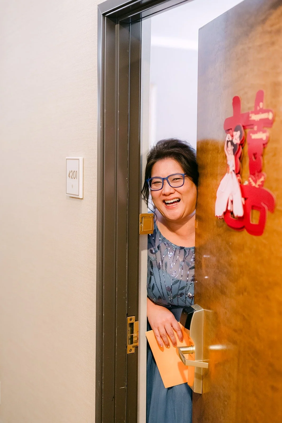 A guest peeks out from behind the door as the door game begins