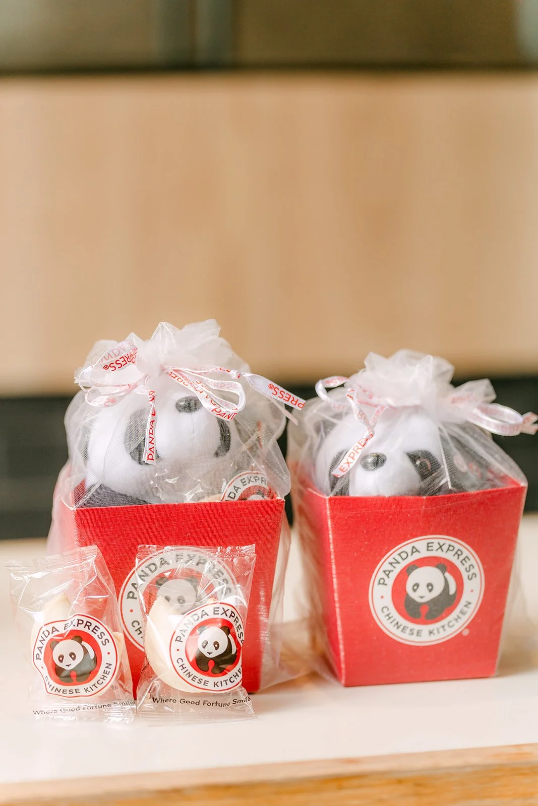 Two Panda Express gift boxes with plush pandas on the table, photographed by One and Only Production.