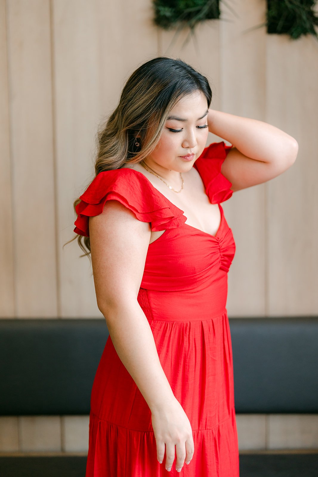 Portrait of Linh in her flutter-sleeve red dress.