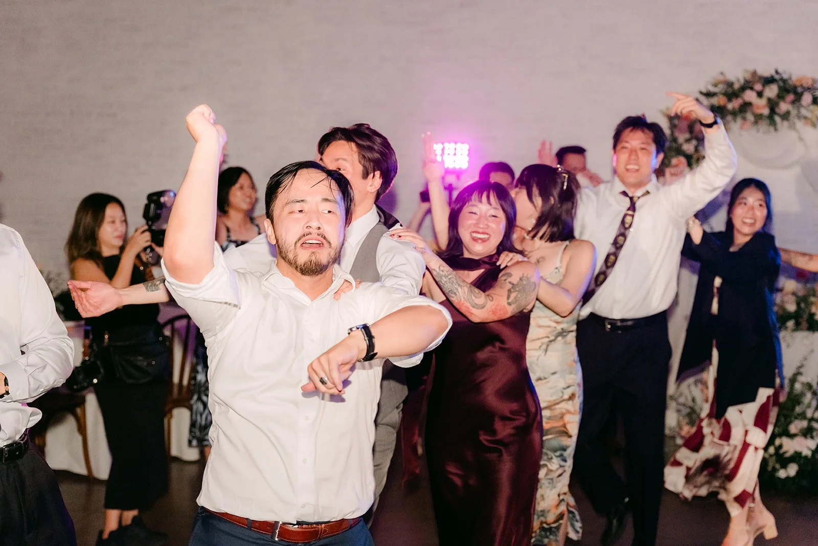 Groomsmen dancing on the packed floor