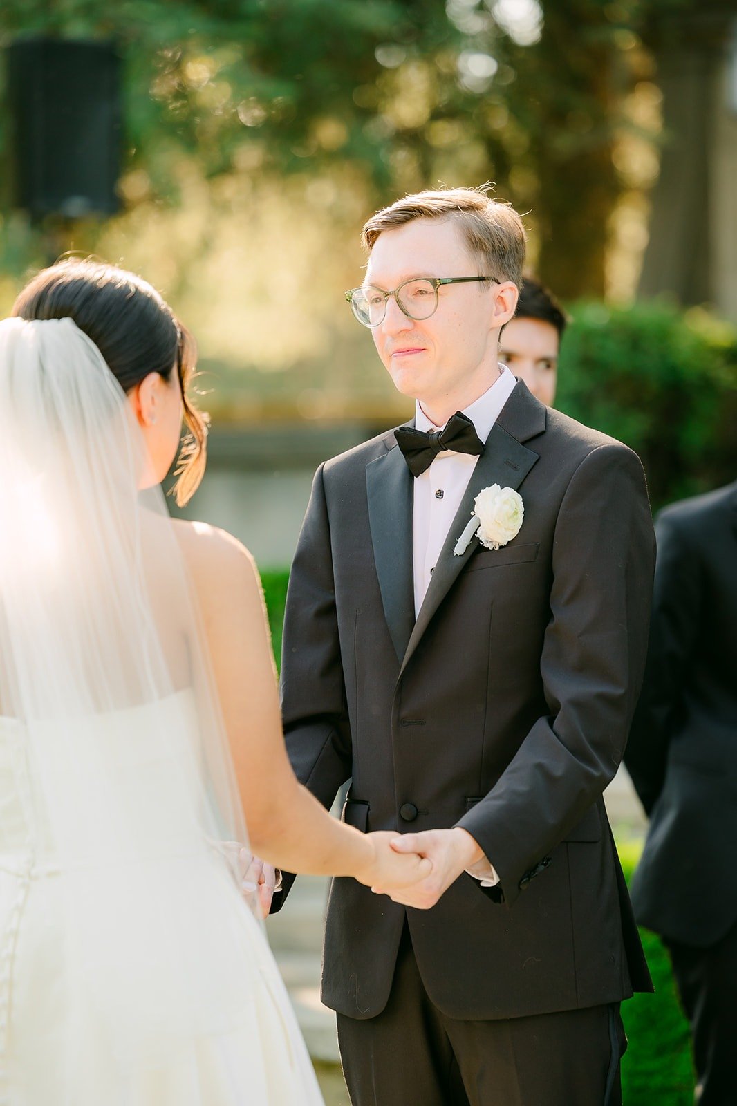 Nik holding both of Brianna's hands as they exchange vows