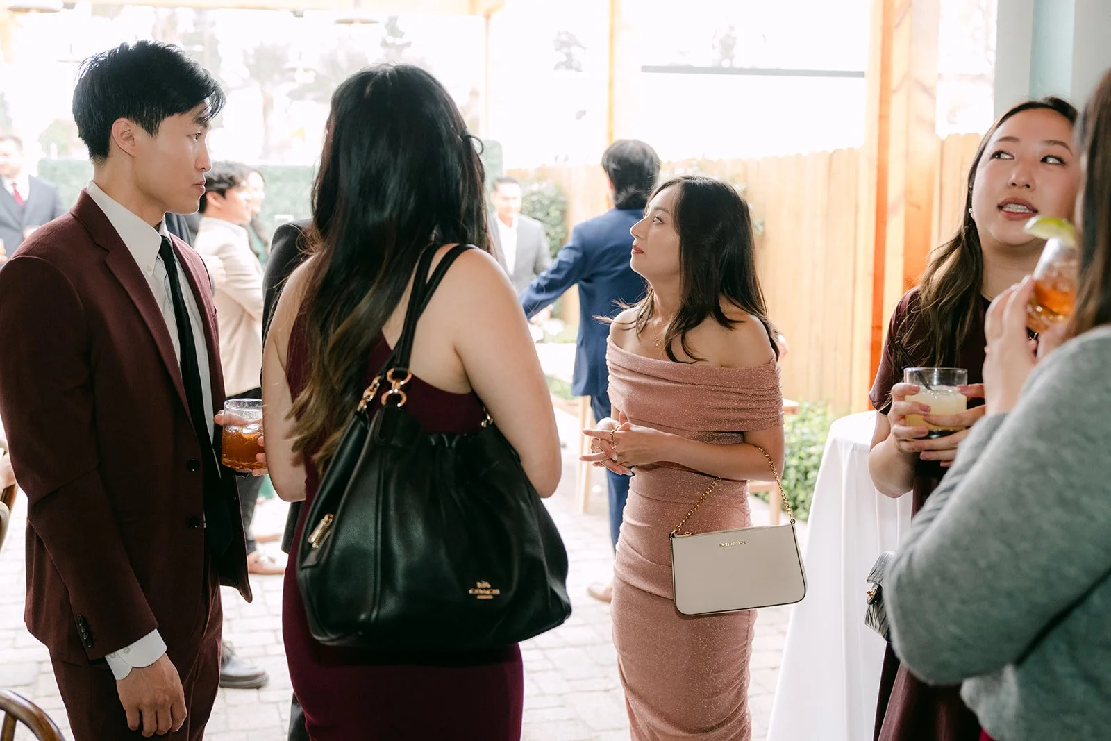 Friends chatting with drinks during cocktail hour.