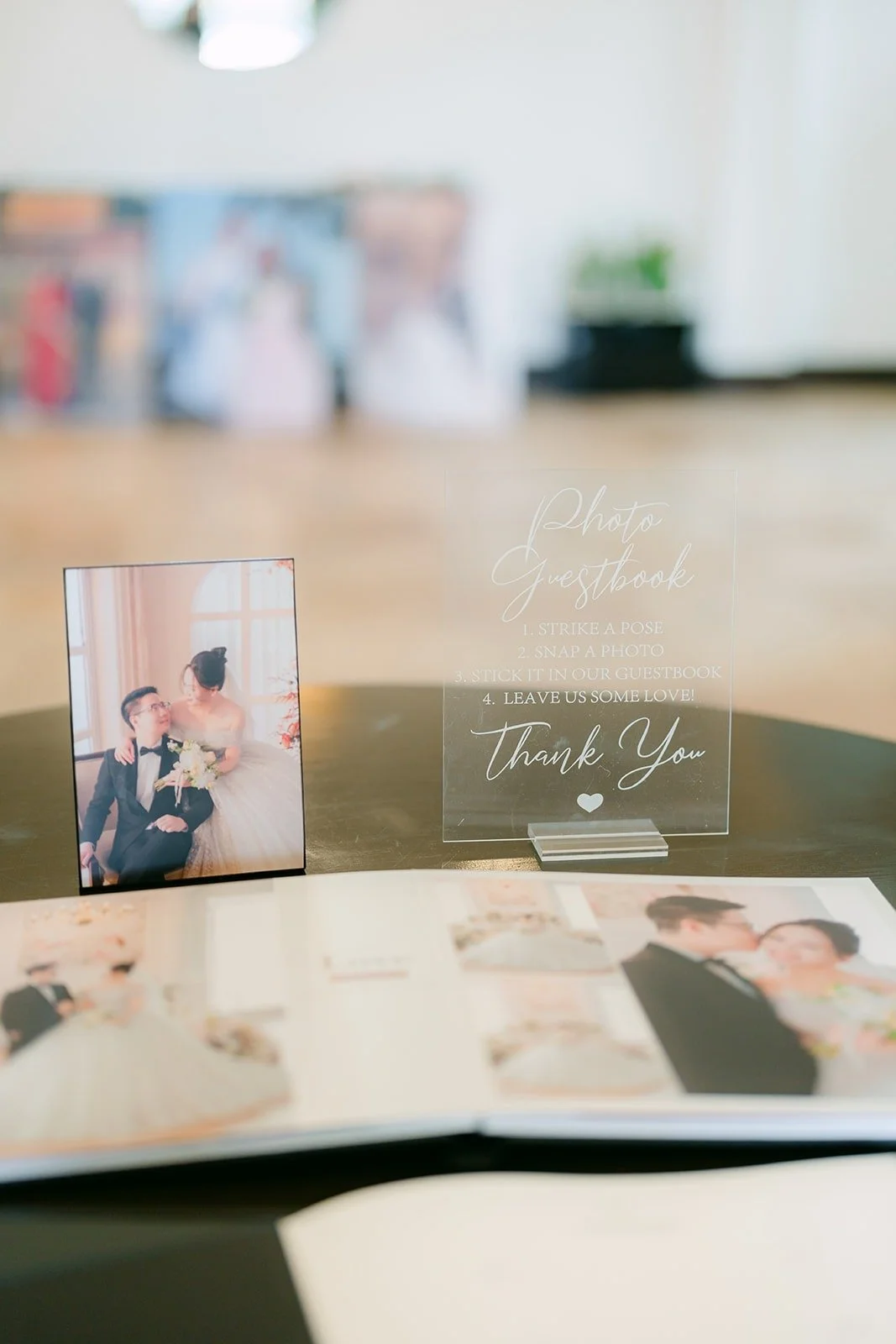 Polaroid guestbook and framed photos of Ivy and Chungman