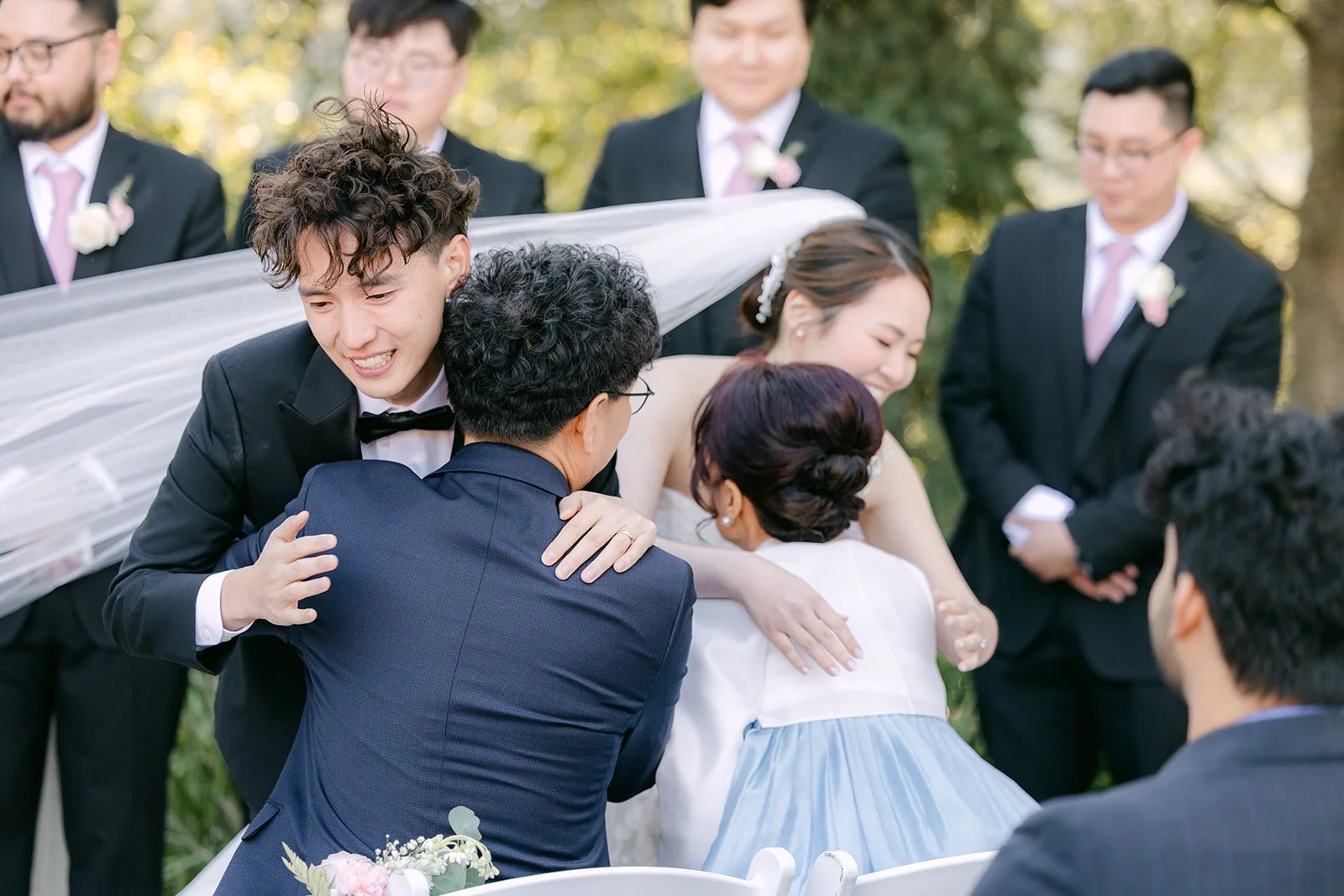 Couple hugging family during the thank-you moment for their parents