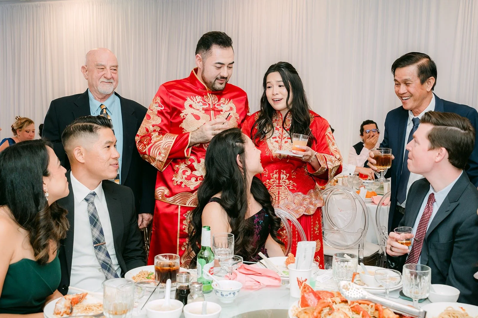 Amy and James toasting with guests during table greetings