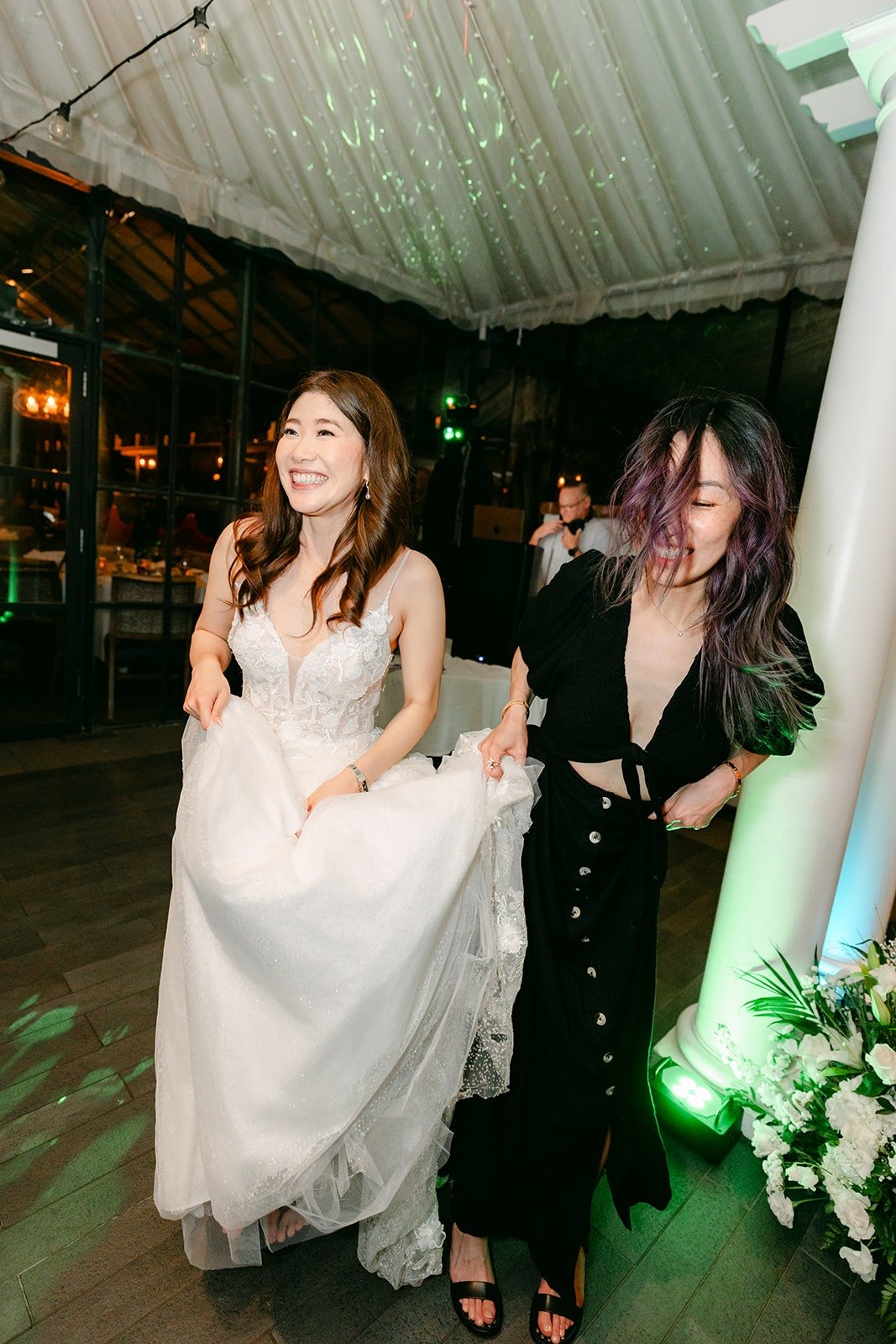 Valerie dancing with a friend under the colored lights