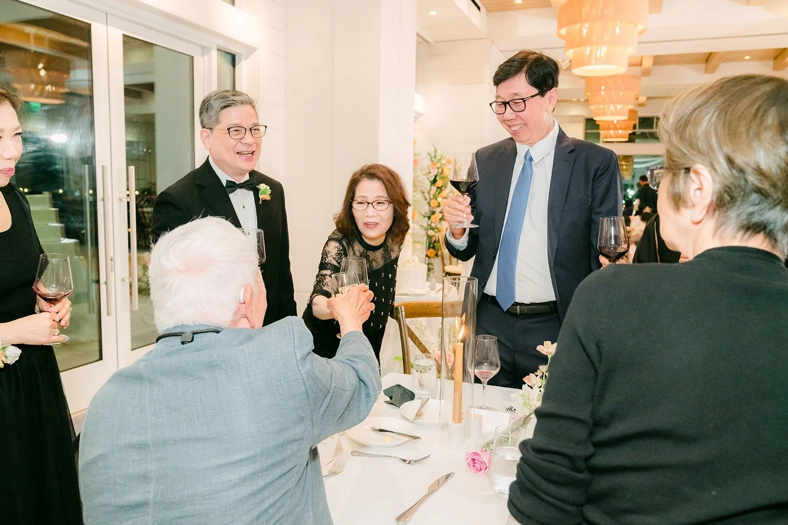 Angela and Eli visiting guests at their tables