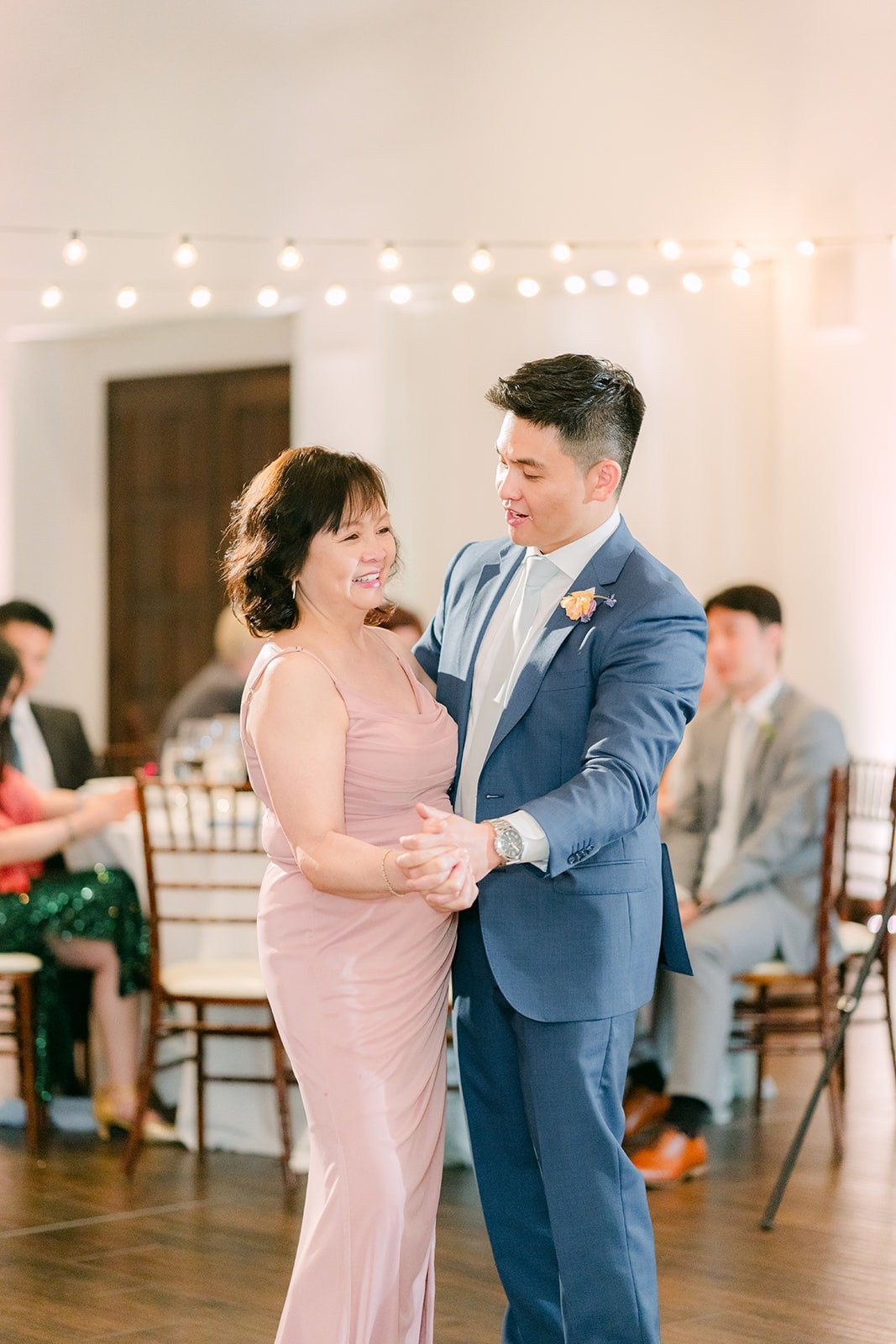 Jerrick dancing with a family member in pink