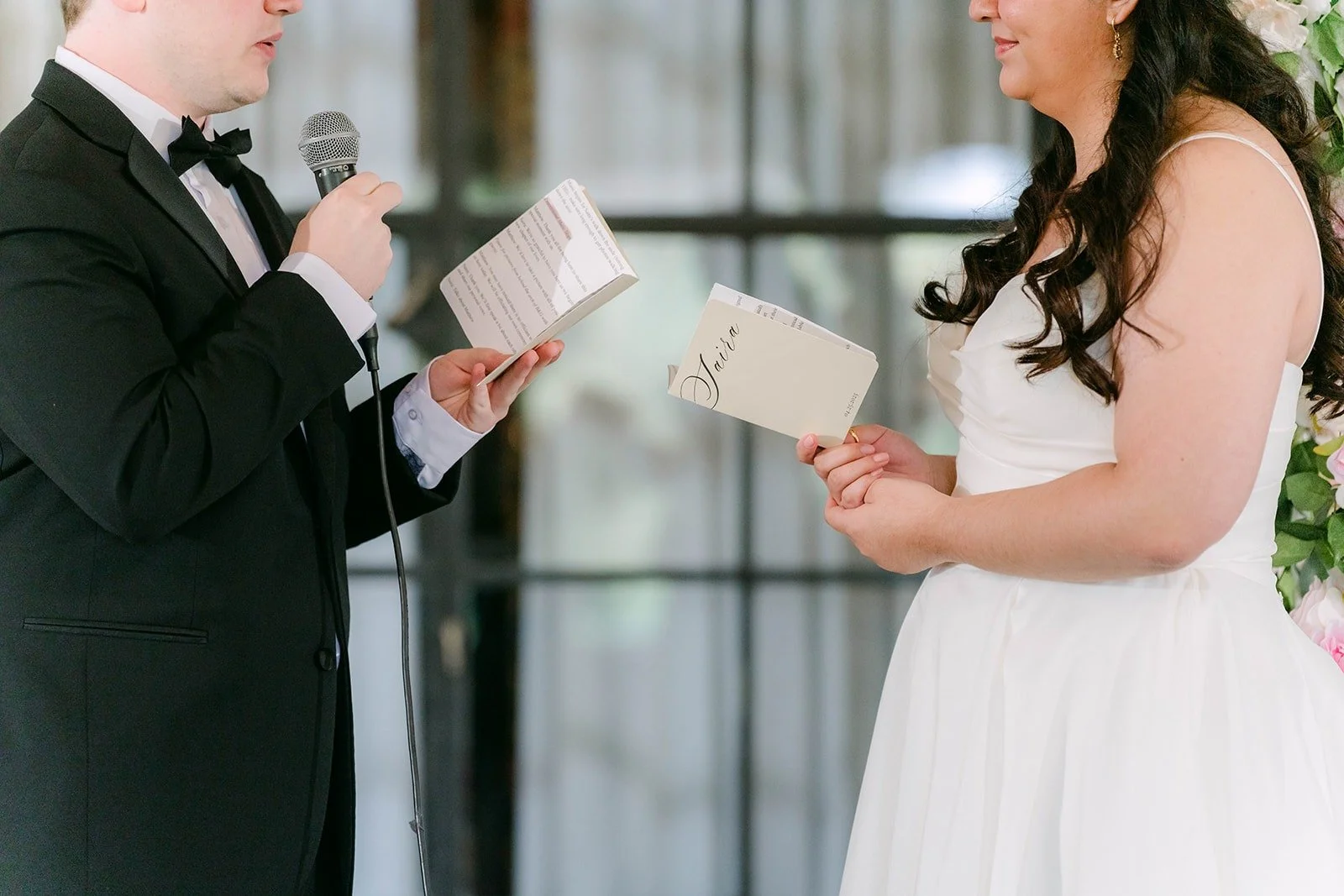 Matthew reading his vows to Saira from a card