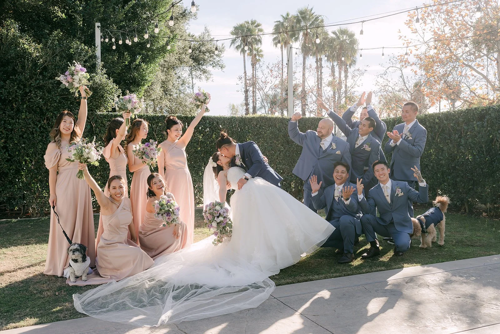 The wedding party gathered around Kate and Michael on the lawn.