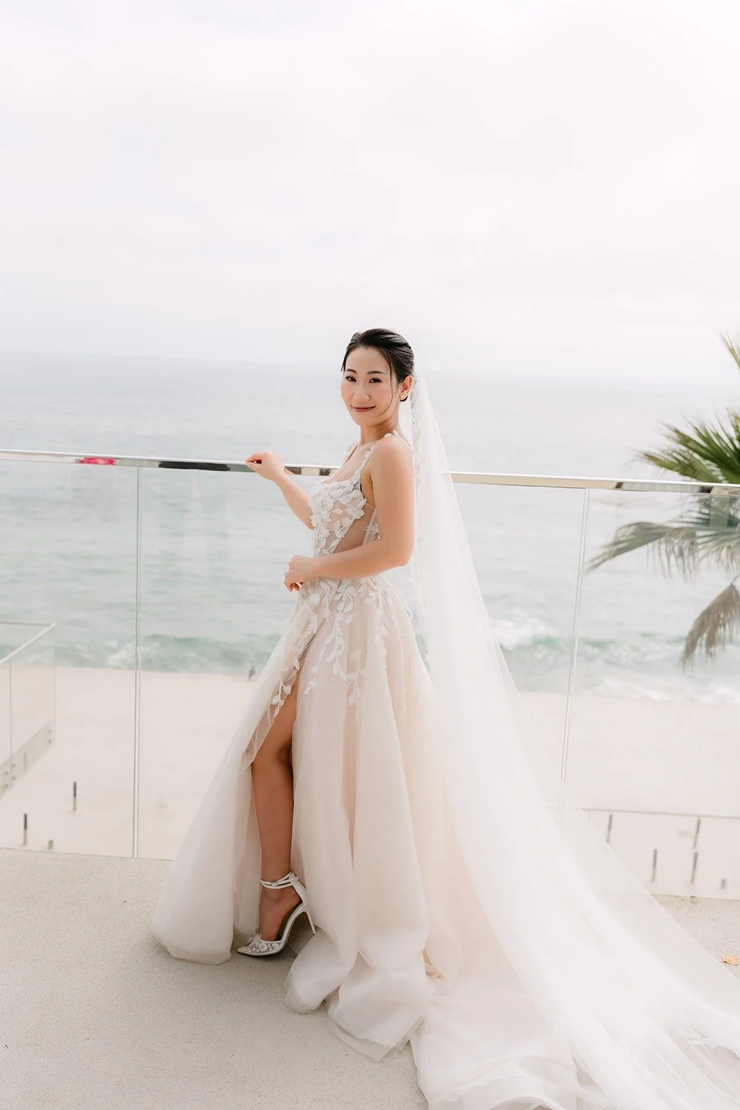 Kylie posing on the oceanfront terrace with the Pacific behind her