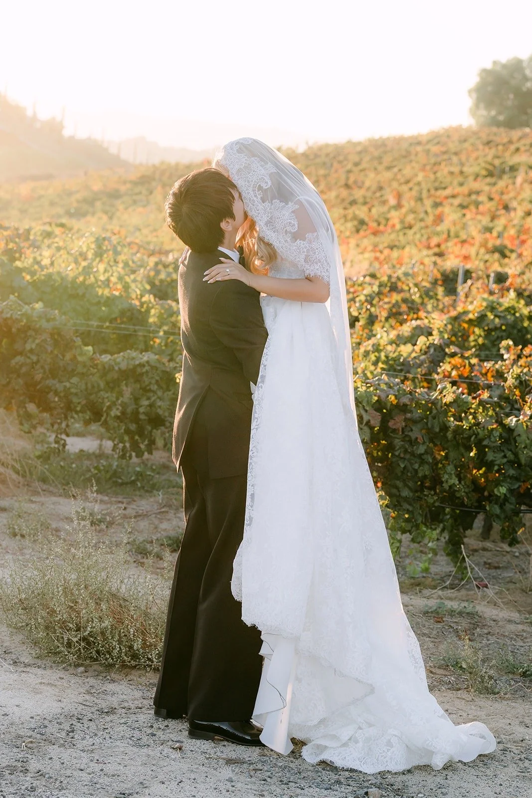 Konitha and Job embracing on the vineyard path
